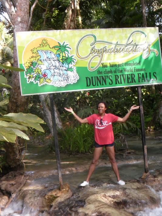 Visitors climbing Dunn's River Falls holding hands in human chain