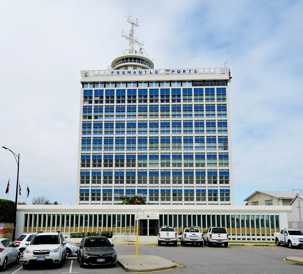 Fremantle Victoria Quay waterfront with heritage limestone buildings lining the harbor under golden afternoon light