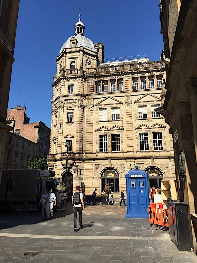Victorian sandstone building in Glasgow city centre with blue police box on Buchanan Street