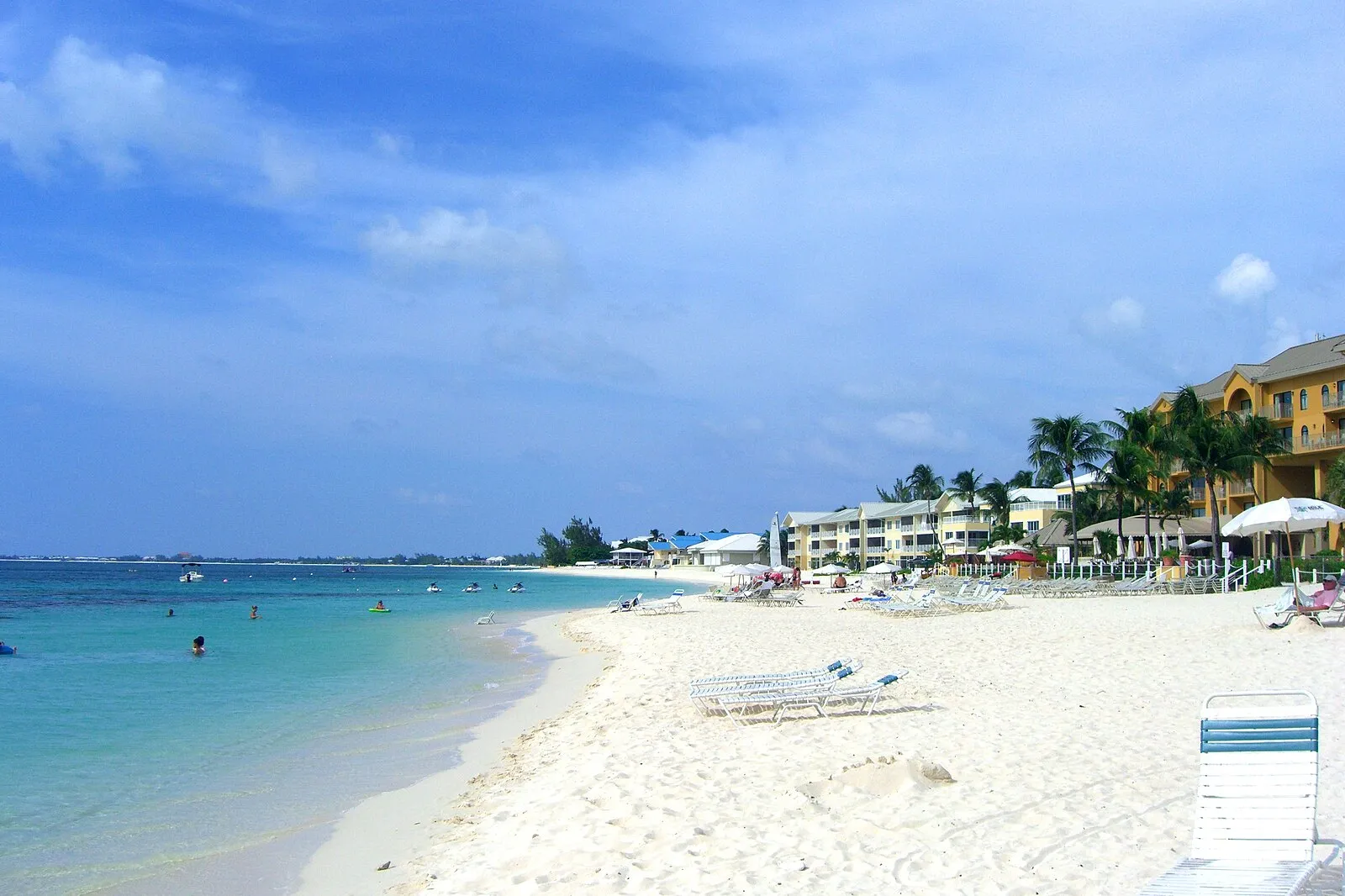 Seven Mile Beach with resort buildings, white sand and turquoise Caribbean water