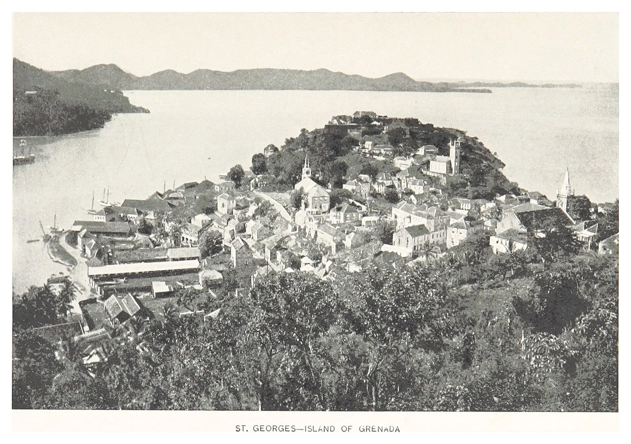 Historic red-tiled roofs of St. George's climbing the hillside above the harbor