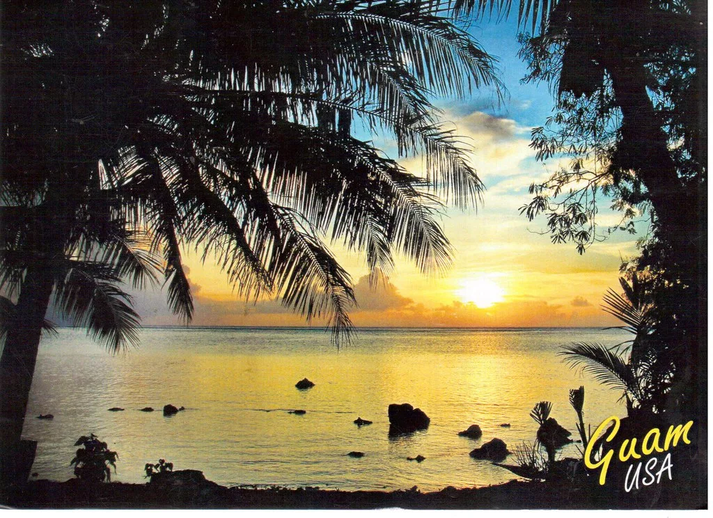 Apra Harbor port area with docked vessels and green hills in background