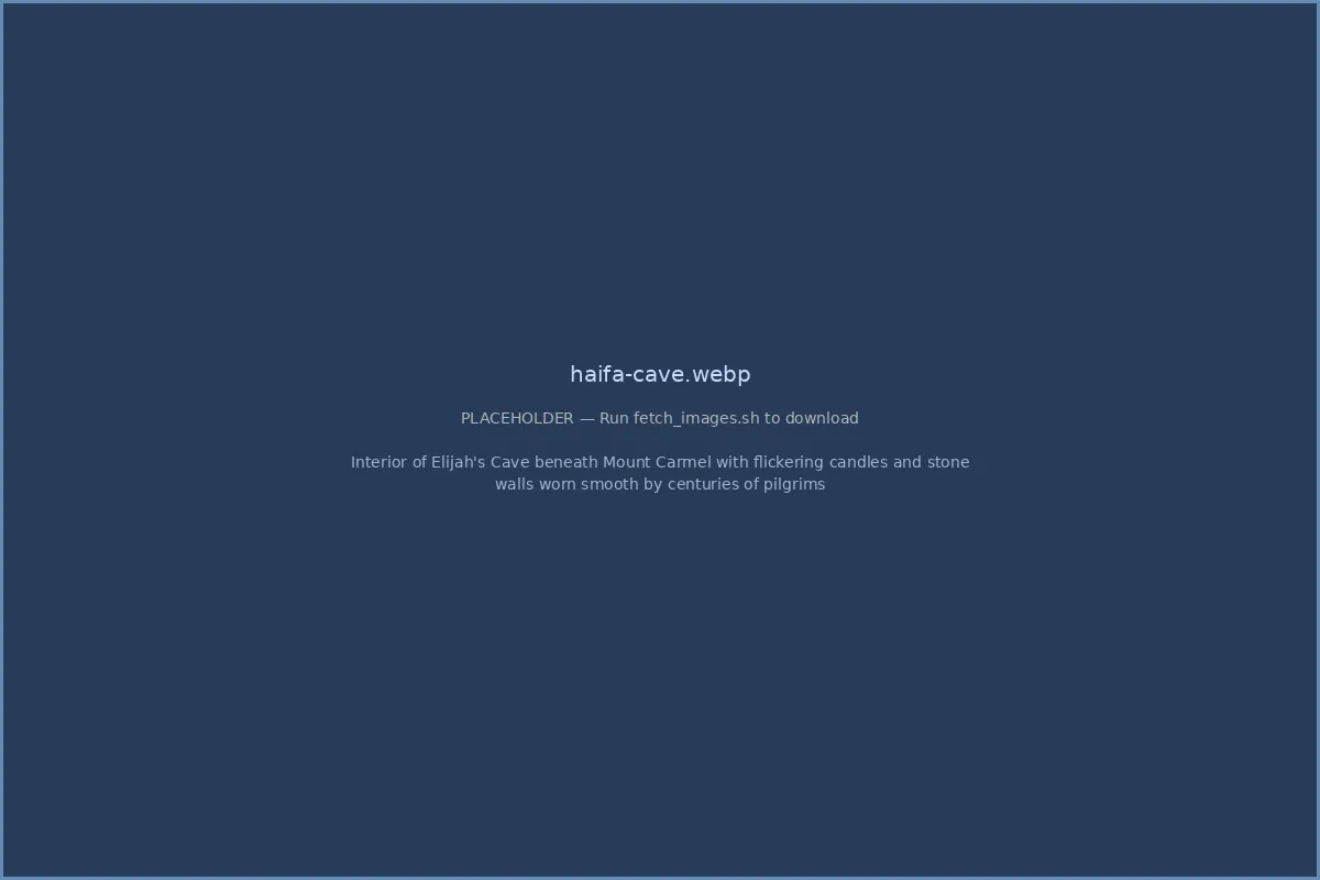 Interior of Elijah's Cave beneath Mount Carmel with flickering candles and stone walls worn smooth by centuries of pilgrims