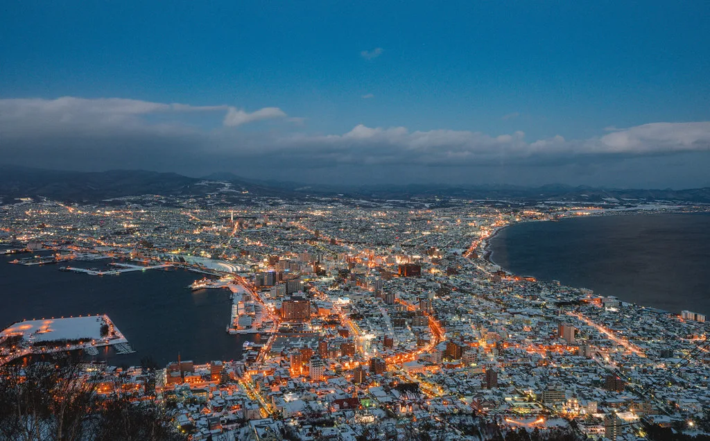 Hakodate harbor at dawn with Mount Hakodate rising behind the port city