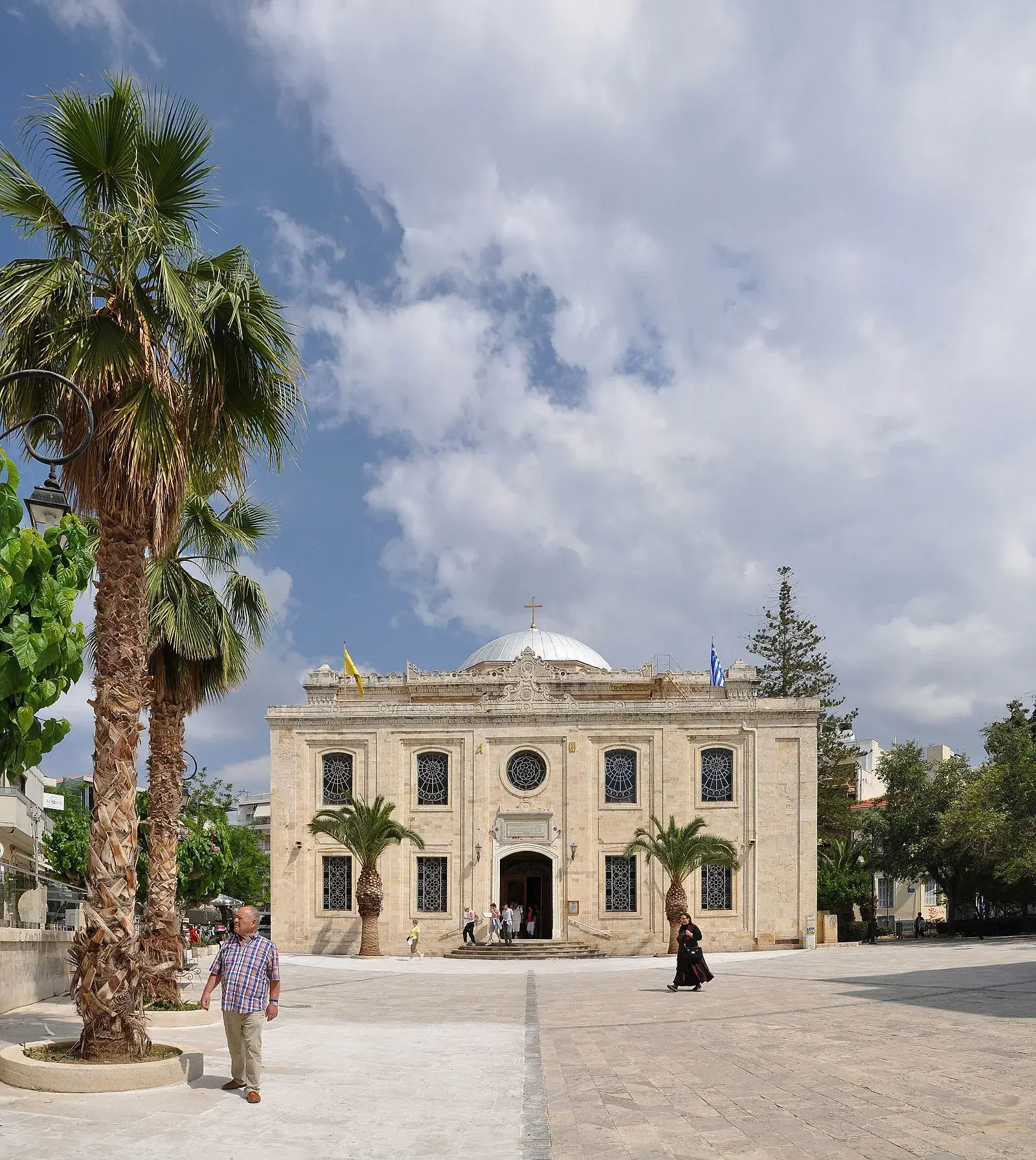 Agios Titos church with dome and Greek flag on the square in Heraklion