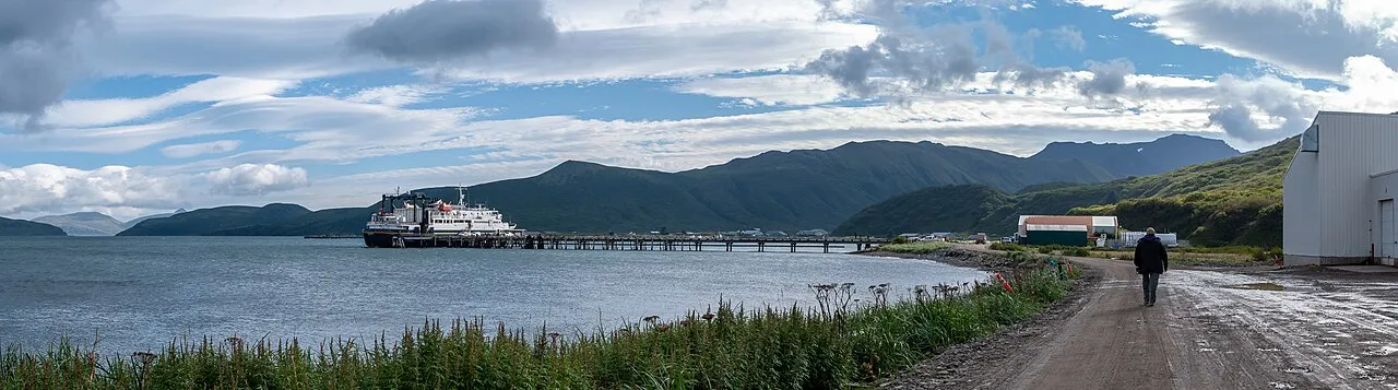 Charter fishing boat returning to Homer Spit harbor with a large halibut catch on display