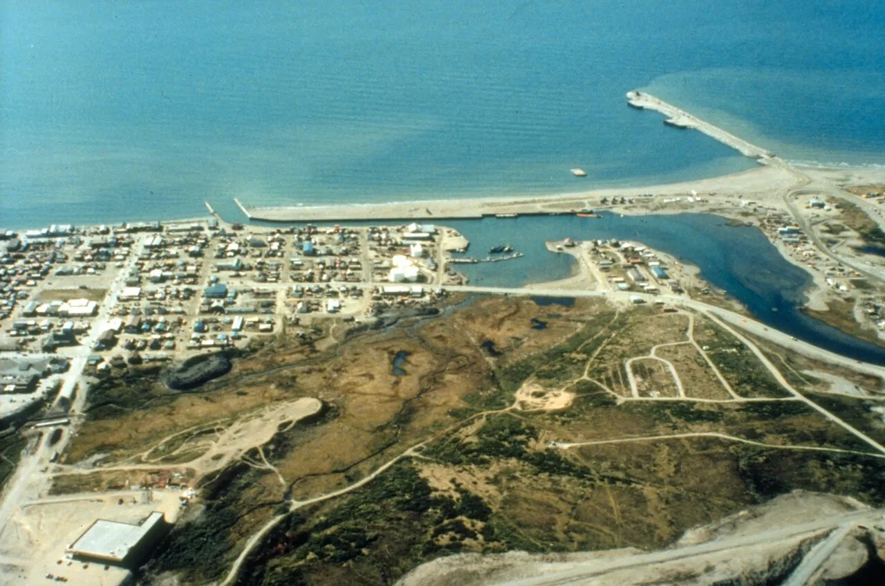 The weathered Salty Dawg Saloon lighthouse building at the end of Homer Spit with dollar bills covering the interior walls
