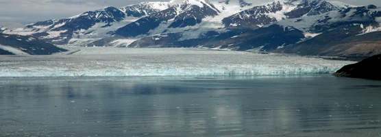 The wide calving face of Hubbard Glacier in Disenchantment Bay with St. Elias Mountains behind