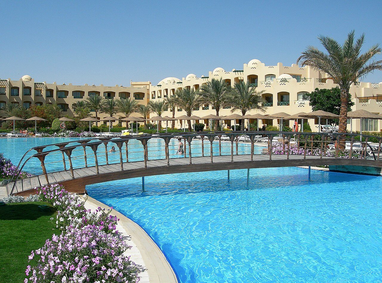 Narrow street in Ad-Dahar old town with traditional Egyptian architecture and local shopkeepers