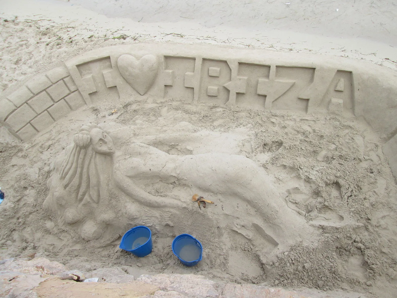 Ancient stone entrance to the Puig des Molins necropolis with carved Phoenician chambers visible beyond the threshold