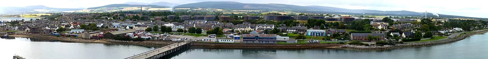 Panoramic of Invergordon waterfront with oil tanks and Highland scenery
