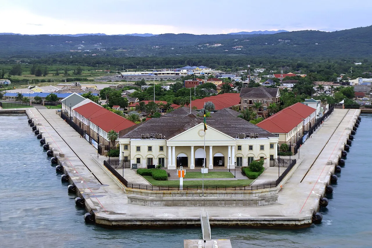 Falmouth cruise port with Royal Caribbean cruise ship docked at the modern terminal and Georgian town buildings visible