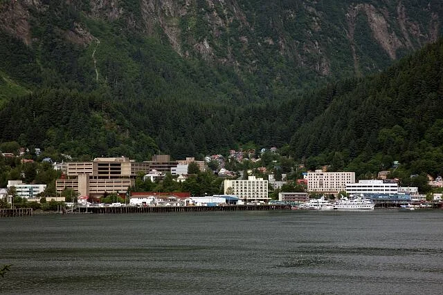 Downtown Juneau waterfront from across Gastineau Channel with steep forested mountains behind