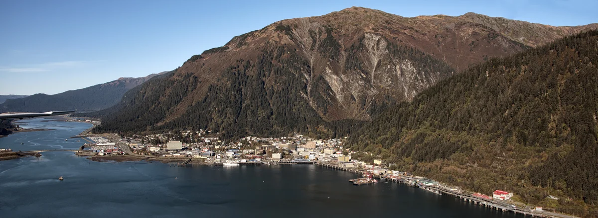 Aerial view of Juneau Alaska and Gastineau Channel with snow-capped mountains and downtown waterfront