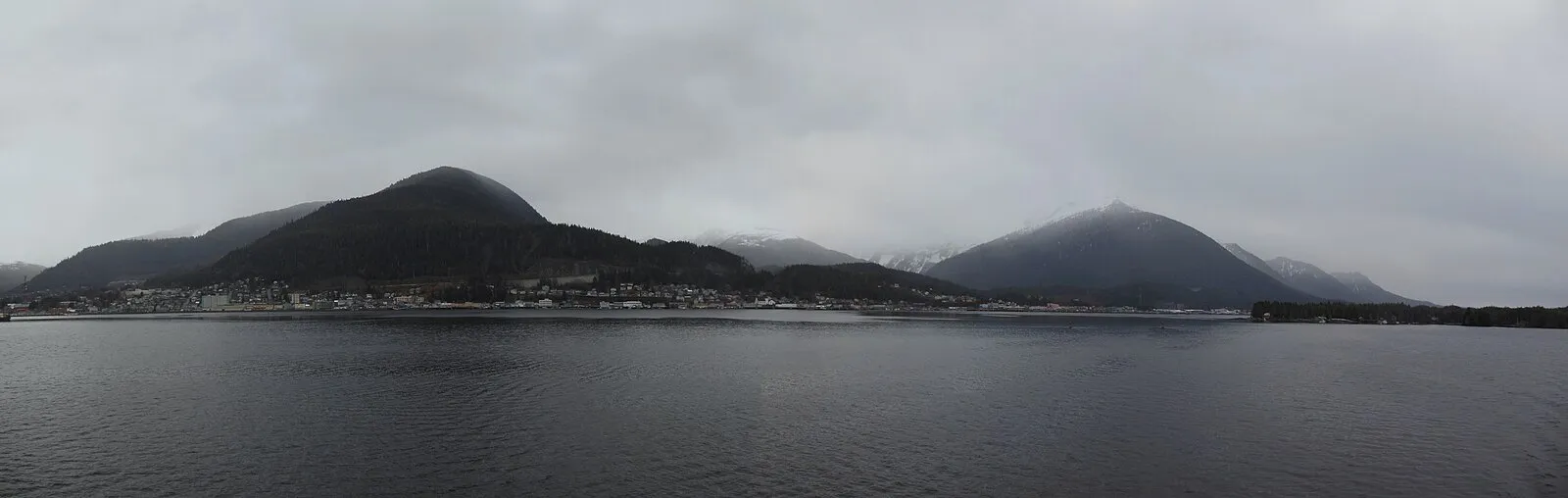 Ketchikan from the sea on an overcast day with forested mountains