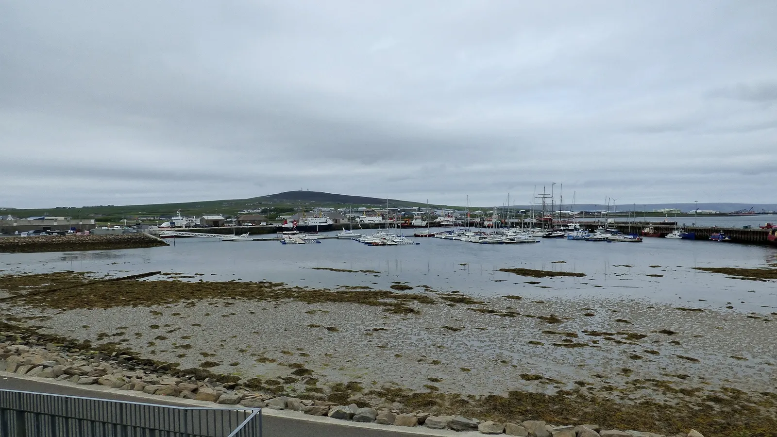 Kirkwall marina panoramic with Wideford Hill and boats at low tide