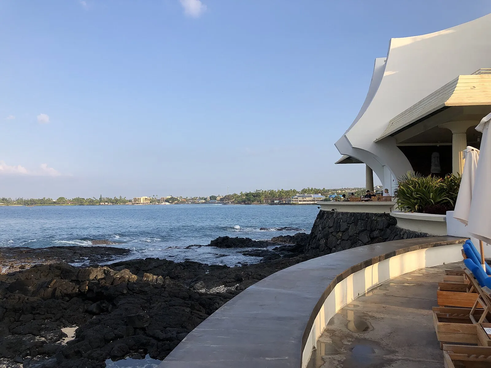 Oceanfront restaurant on lava rock with Kailua Bay beyond