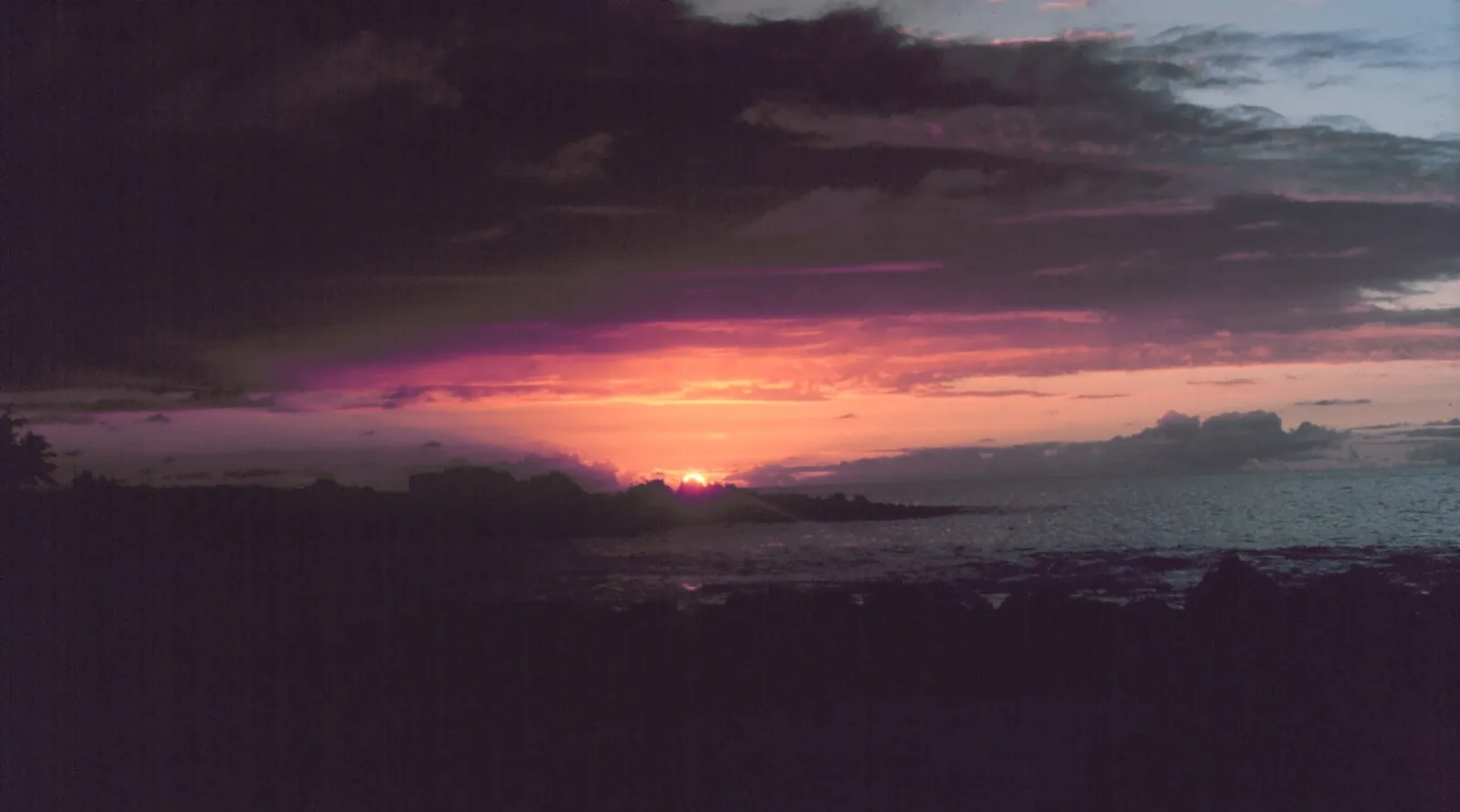 Dramatic purple and pink sunset over the Kona coast