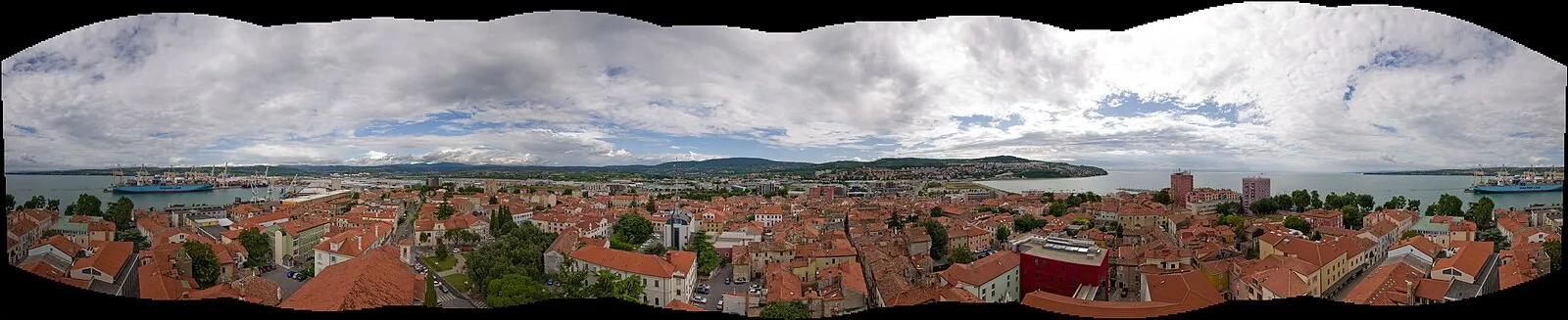 360-degree panorama of Koper from cathedral bell tower showing red rooftops, port, bay, and surrounding landscape