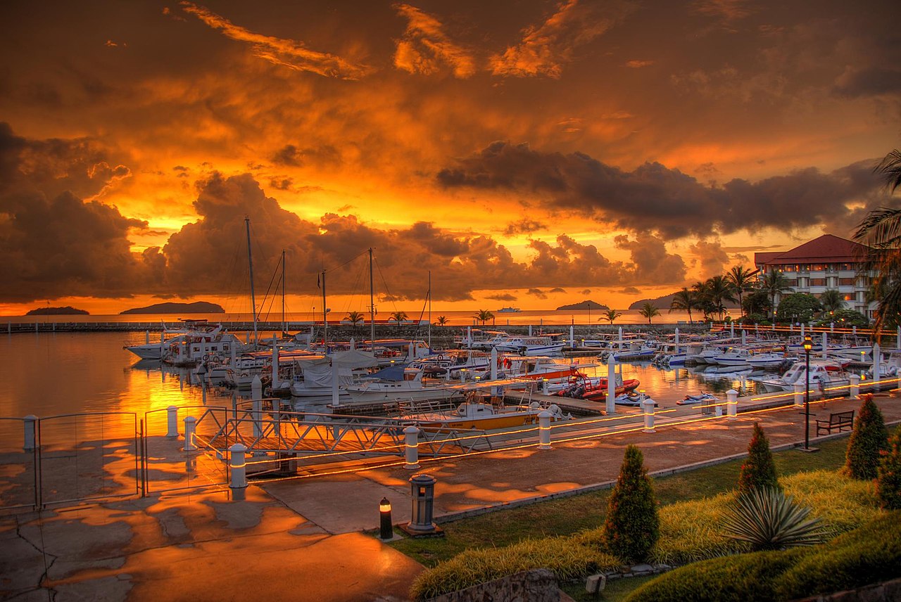 Kota Kinabalu harbor with colorful fishing boats and Jesselton Point ferry terminal in the tropical morning light