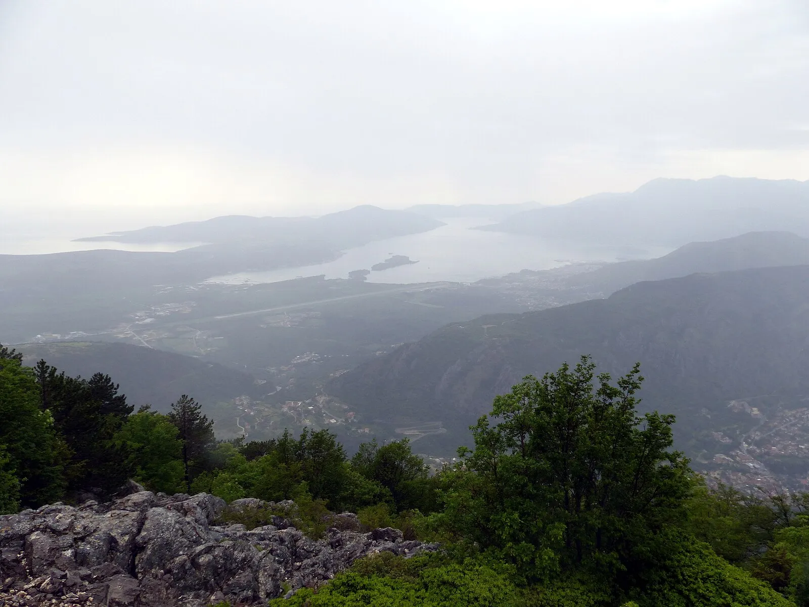 The Baroque village of Perast on the Bay of Kotor with stone palazzos lining the waterfront and mountains behind