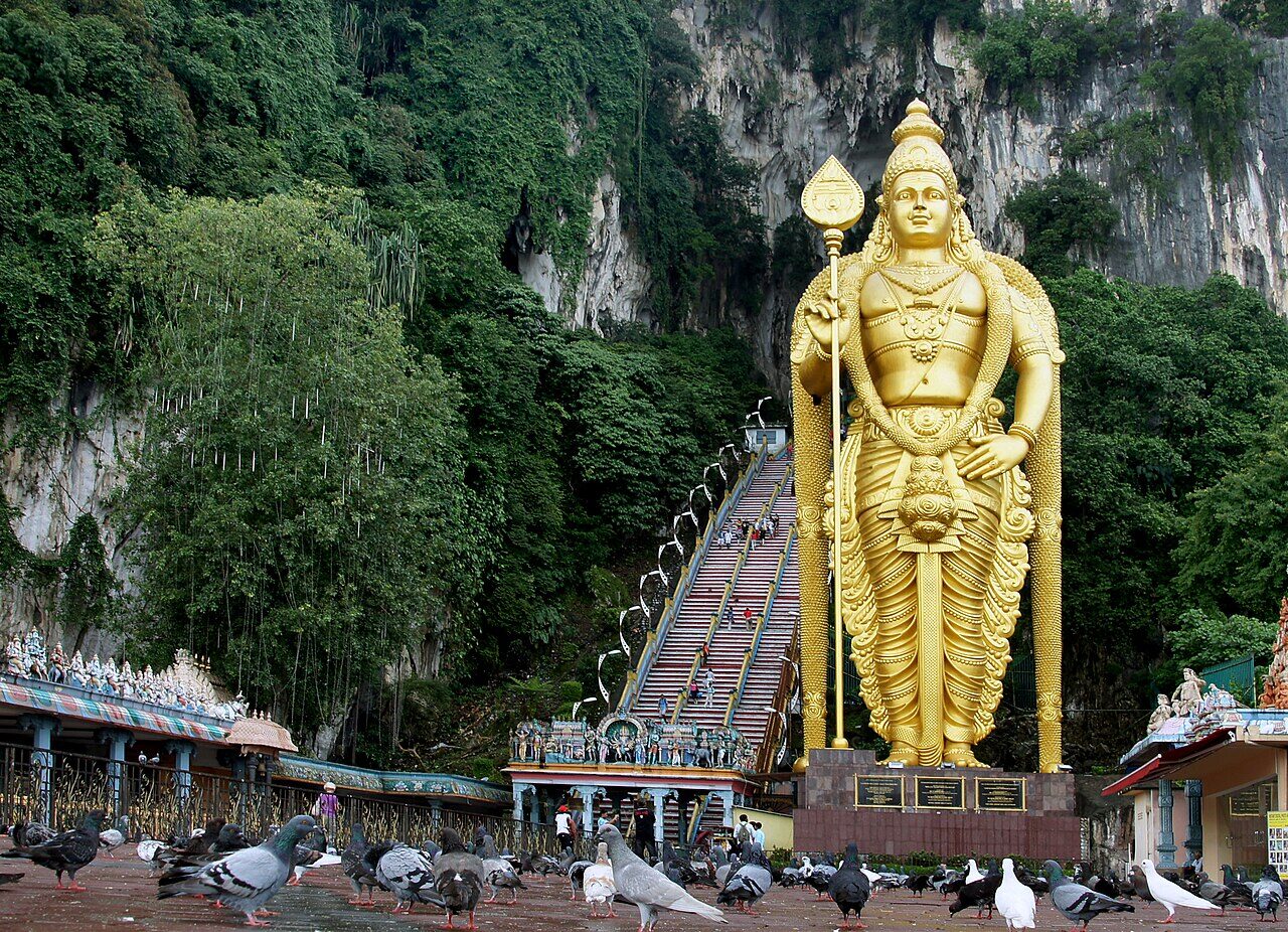 Batu Caves with the golden Lord Murugan statue and 272-step staircase