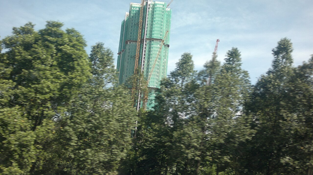 KL Tower telecommunications spire rising above tropical forest canopy on Bukit Nanas hill