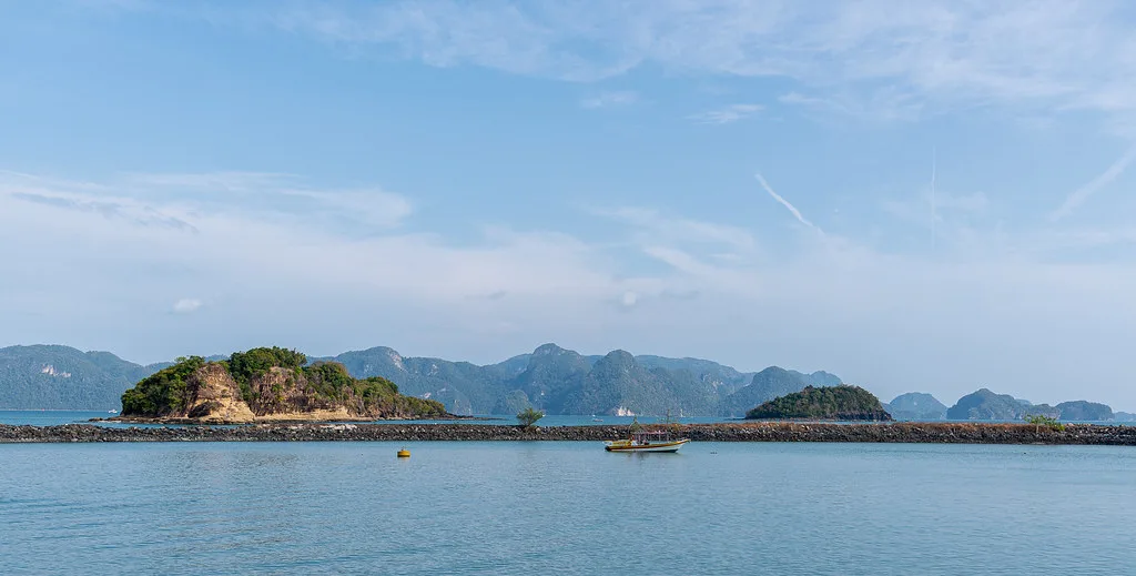 Curved SkyBridge walkway suspended between mountain peaks with valley views below