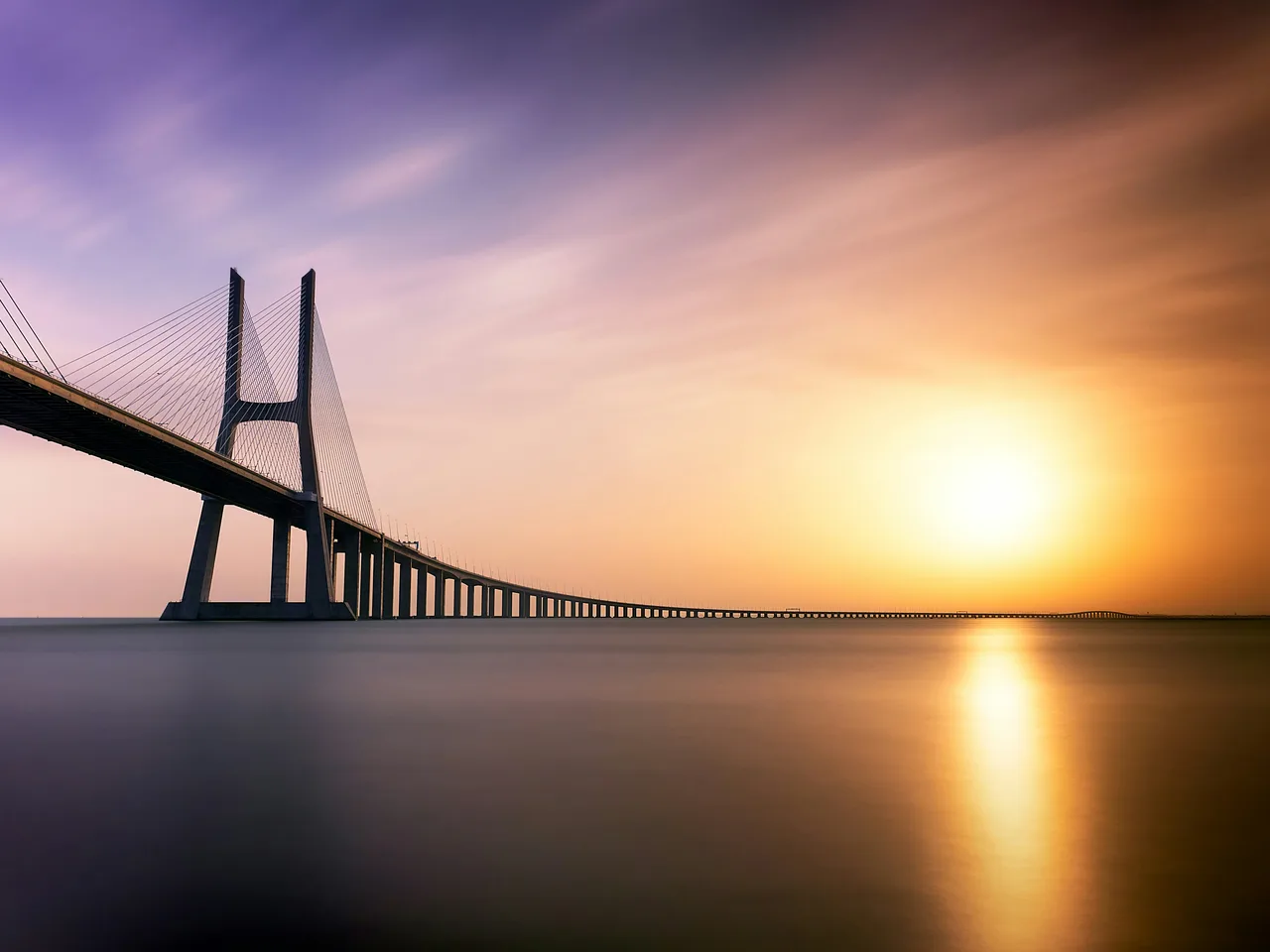 Vasco da Gama Bridge at sunset over the Tagus River, Lisbon