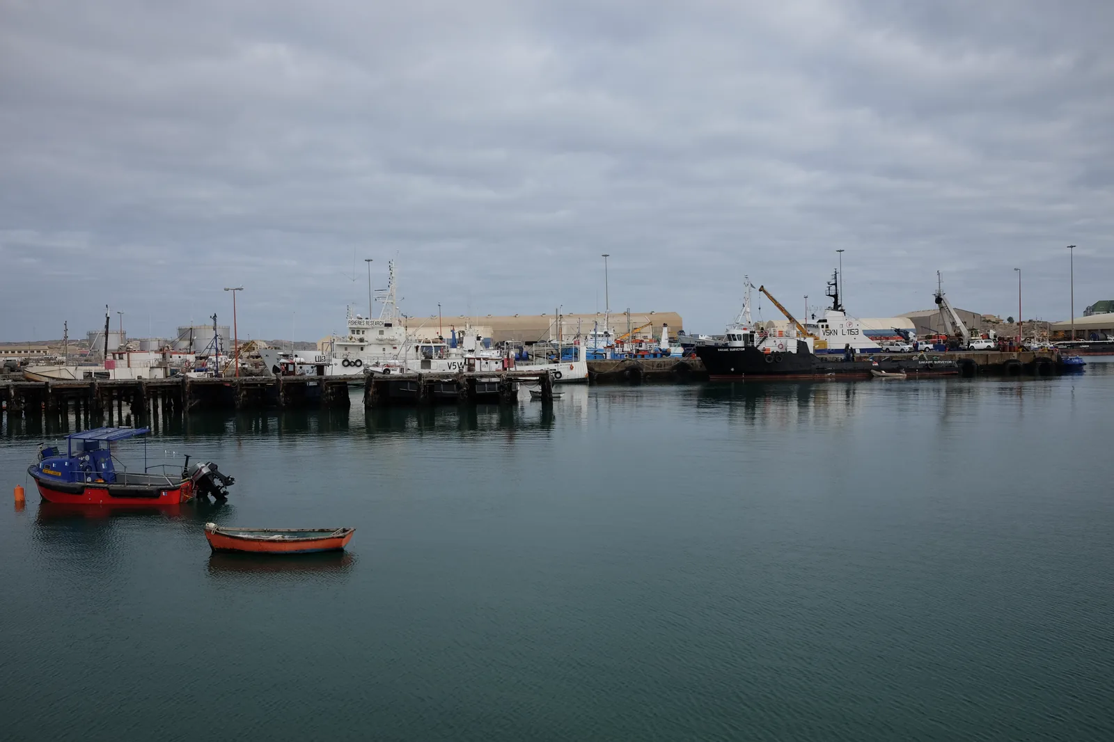 The quay at Lüderitz harbour with fishing vessels alongside and the town behind
