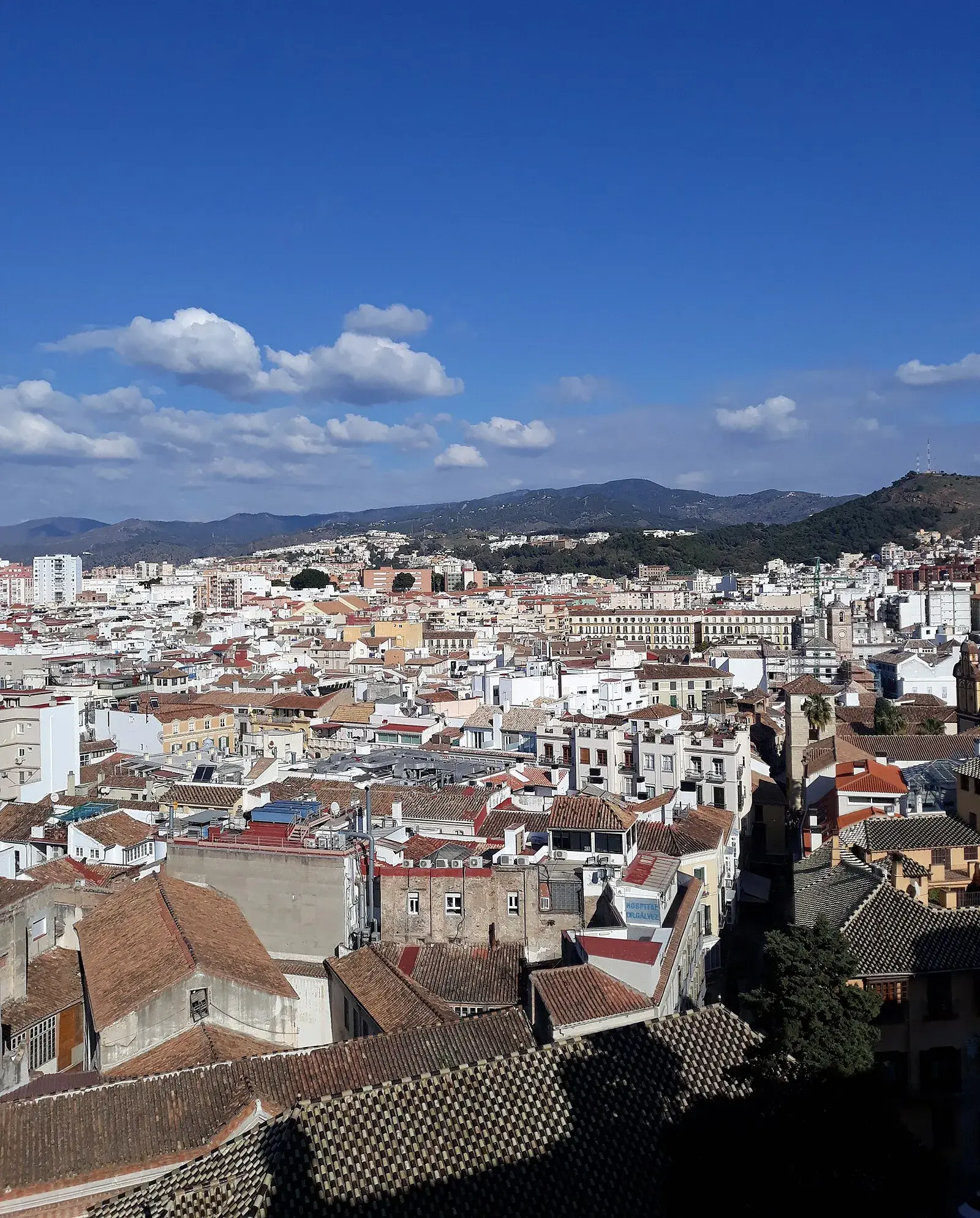 Rooftop view over Málaga old town with terracotta roofs and mountains