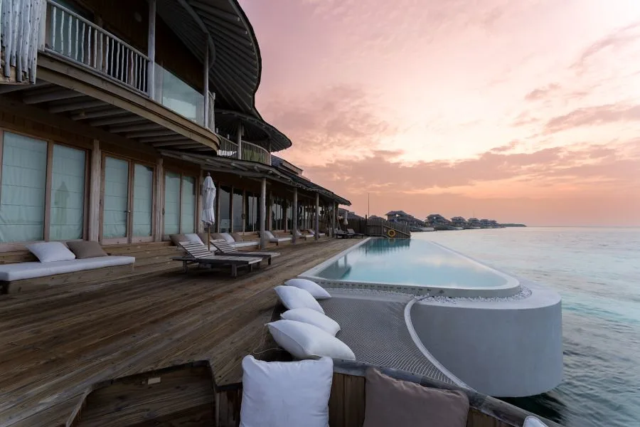 Panoramic aerial view of a Maldivian atoll surrounded by turquoise Indian Ocean waters