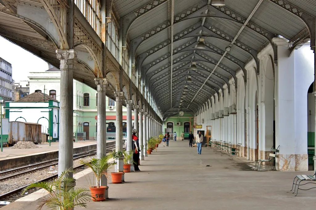 Panoramic view of Maputo harbor with fishing boats and the Indian Ocean coastline stretching into the distance