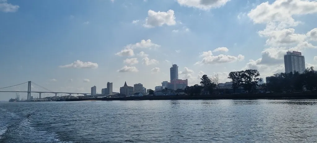 Maputo's iconic CFM Railway Station with copper dome overlooking the harbor at sunrise