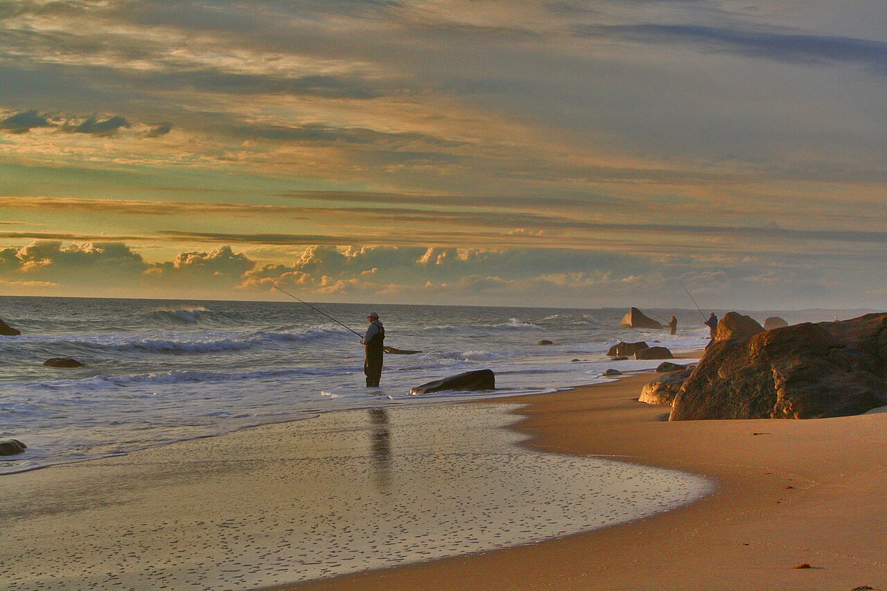 Surf fishing at sunset on Martha's Vineyard beach