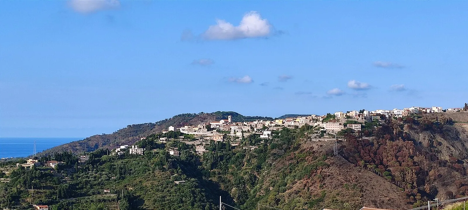 Sicilian hillside village near Messina with Mediterranean Sea