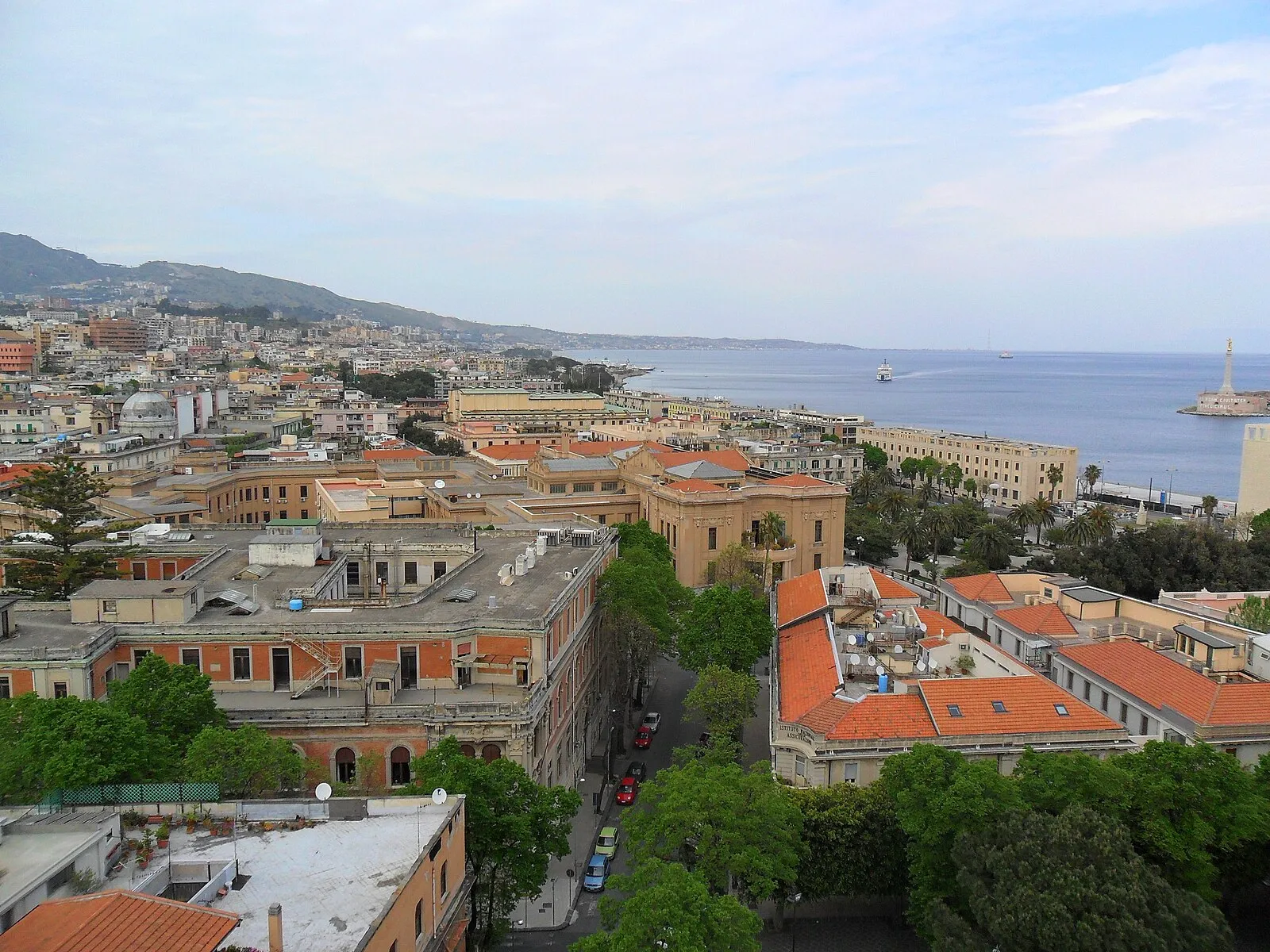 Elevated panoramic over Messina city, harbor, and Strait with Calabria