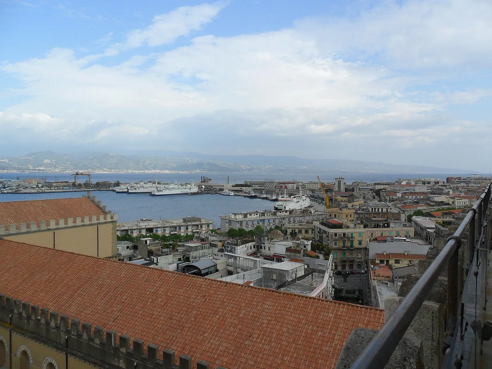 Rooftop view of Messina harbor with ferries and Strait to Calabria