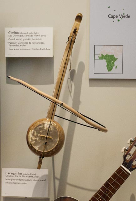 The vibrant Praça Nova square in Mindelo with pastel colonial buildings and outdoor café tables beneath palm trees