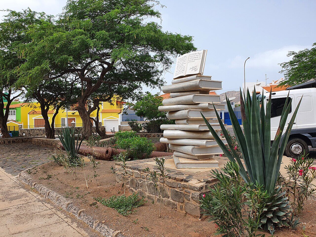 The Torre de Belém replica on Mindelo's waterfront with the harbor and volcanic hills visible in the background