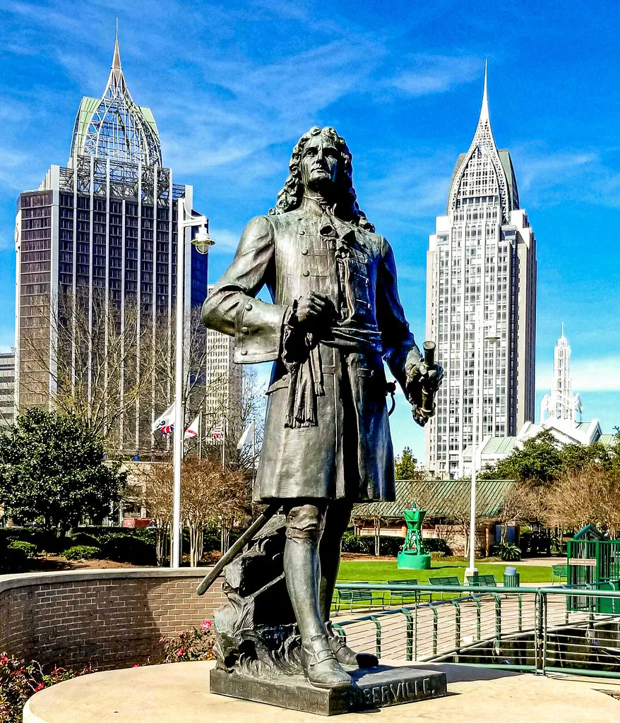 Mobile Alabama skyline viewed from the waterfront with the Mobile River and downtown buildings visible at golden hour