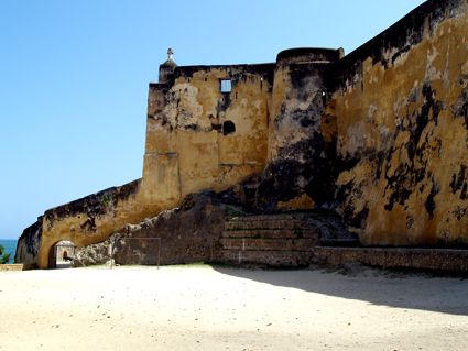 Fort Jesus entrance and ramparts rising above the Mombasa coastline against a bright sky
