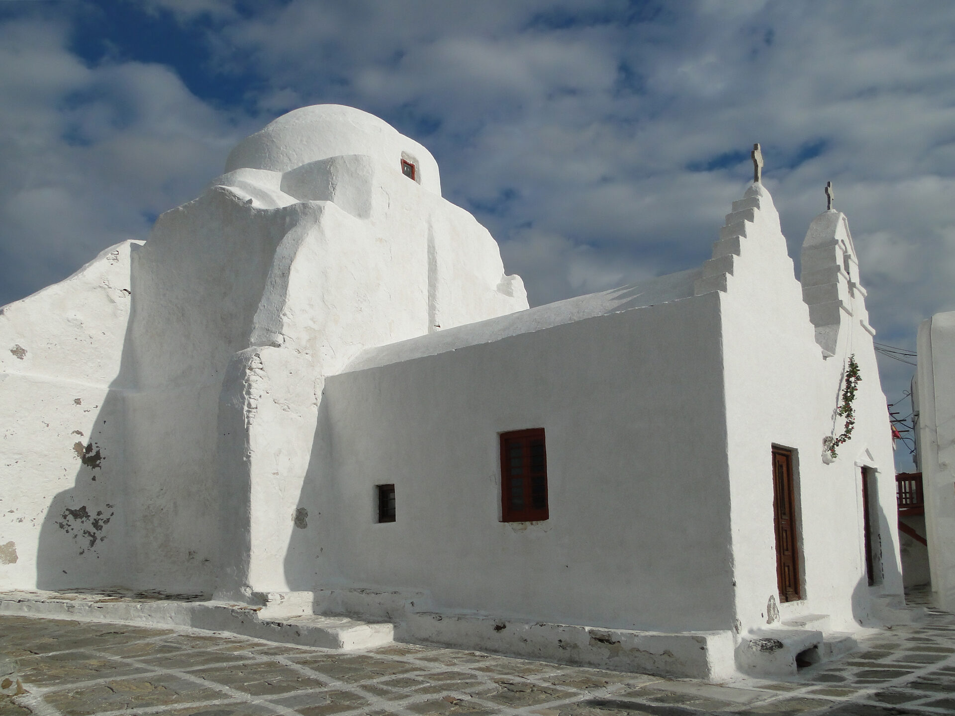 Paraportiani Church with whitewashed asymmetrical architecture and bell tower