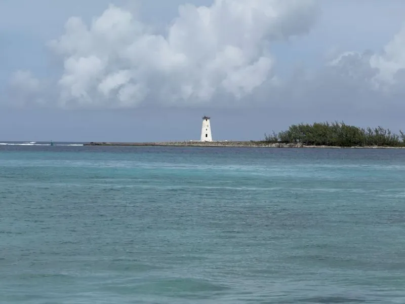Vibrant Nassau waterfront with colorful colonial buildings and palm trees lining the turquoise Caribbean bay