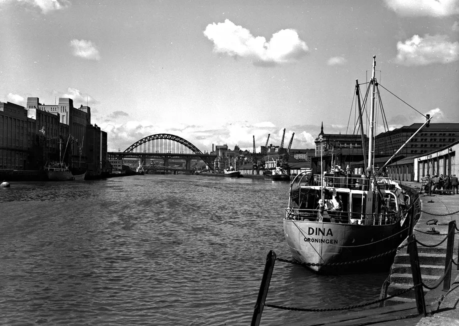 Historical B&W photograph of Newcastle Tyne quayside with vessel DINA Groningen and Tyne Bridge