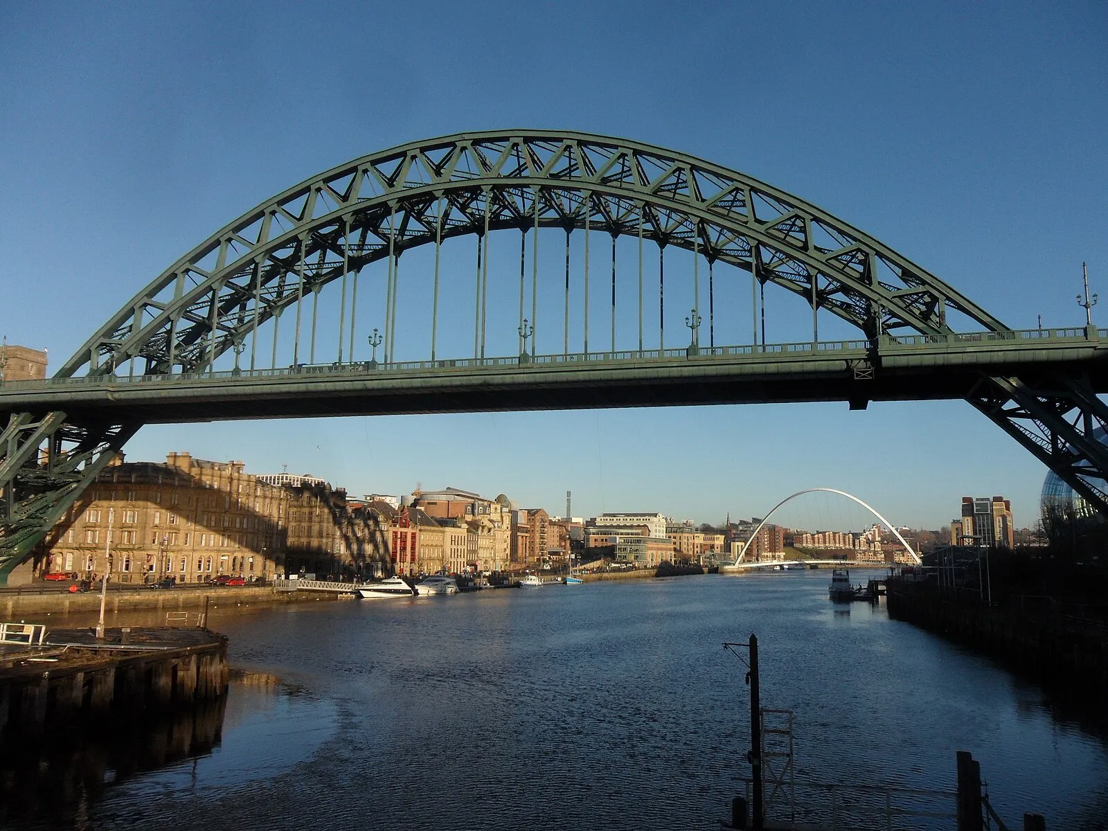 Tyne Bridge from below with Gateshead Millennium Bridge in the distance