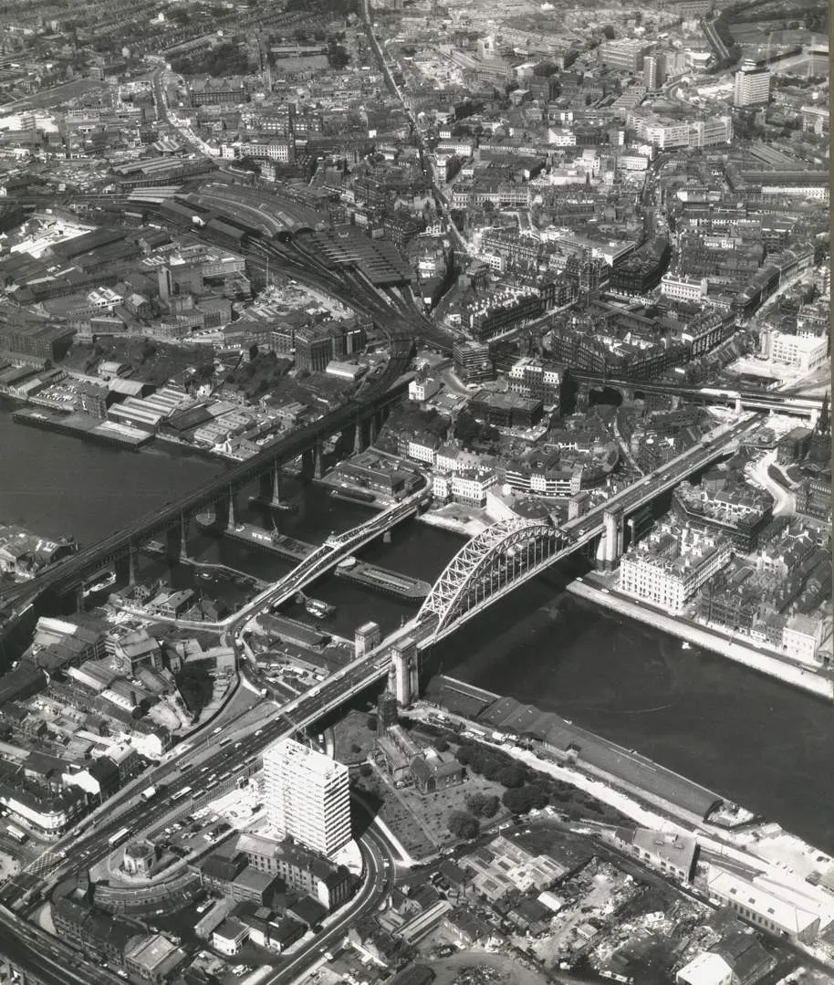 Historical B&W aerial photograph of Newcastle showing Tyne Bridge and multiple river crossings