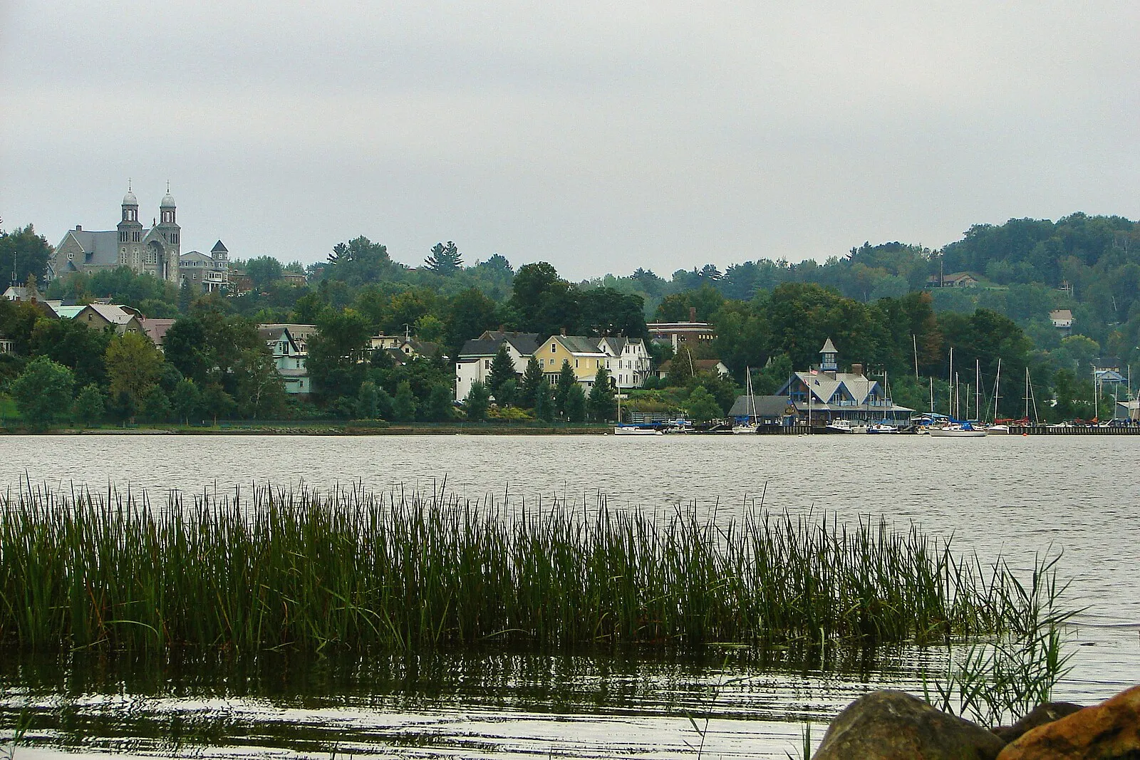 Sailboats racing in Narragansett Bay with the Newport Bridge spanning the horizon behind them