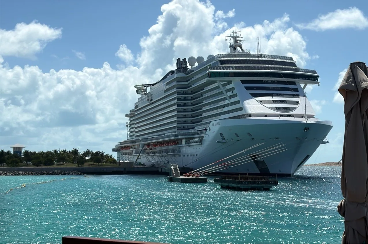 MSC Seaside moored bow-toward-camera at the Ocean Cay pier, mooring lines running to the bollards