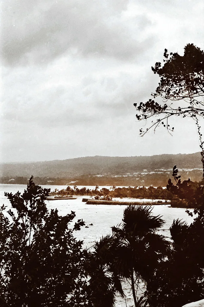 Cruise ship docked at Ocho Rios pier with the town and green hills in the background
